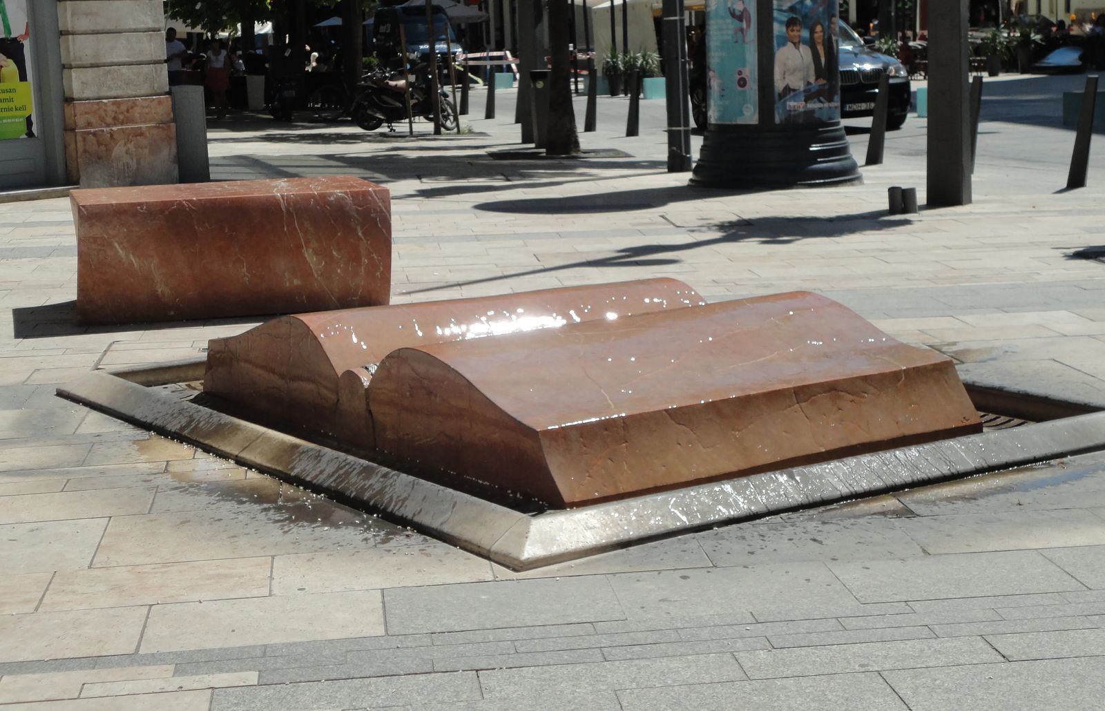 Photo of a fountain shaped like a book with an interesting water effect, located in Budapest, Hungary.