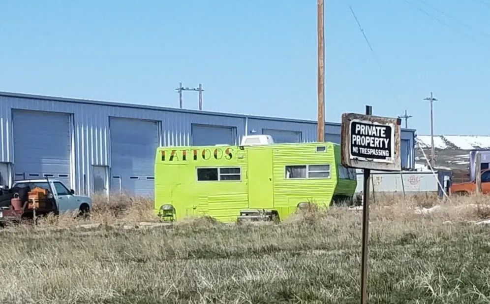 Photo of a bright green tattoo parlor, near Sturgis, South Dakota