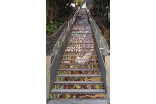 Photo of A cat peering from the mosaic at The bottom end of the hidden garden steps in San Francisco, California