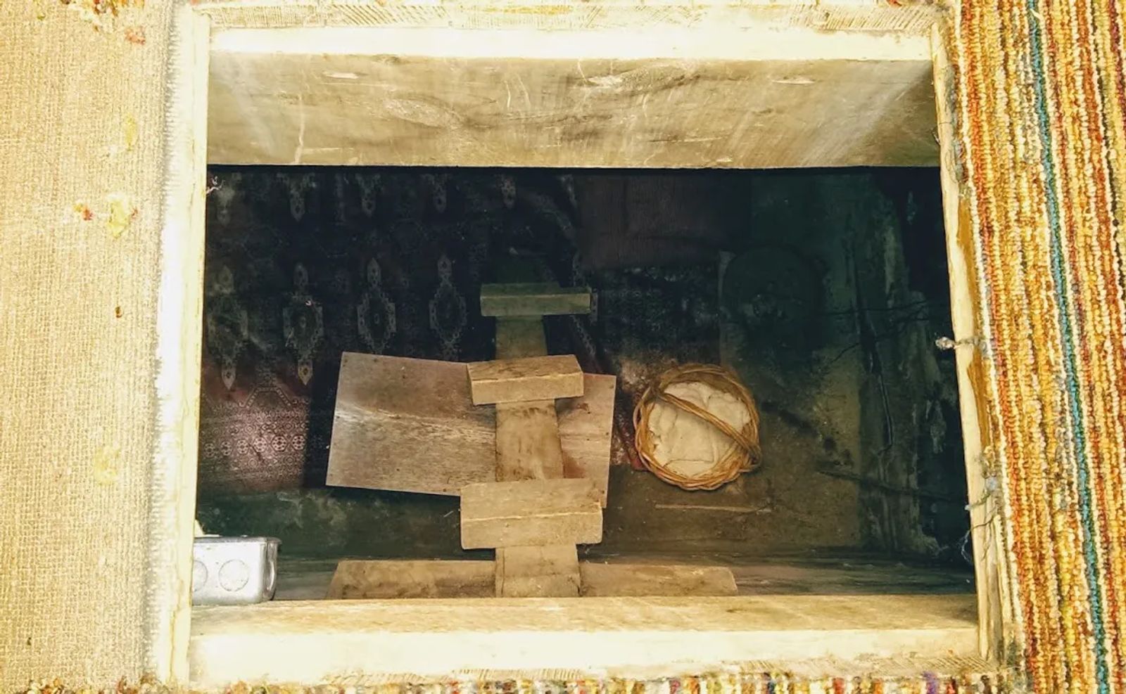 Photo of a trap door that leads to a 4'x4', 8' deep room that was used to hide slaves running to freedom, in Winterset, Iowa.