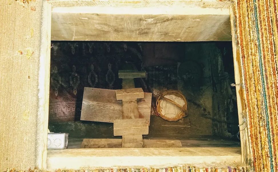 Photo of a trap door that leads to a 4'x4', 8' deep room that was used to hide slaves running to freedom, in Winterset, Iowa.