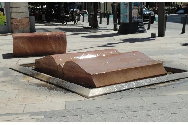 Photo of a fountain shaped like a book with an interesting water effect, located in Budapest, Hungary.
